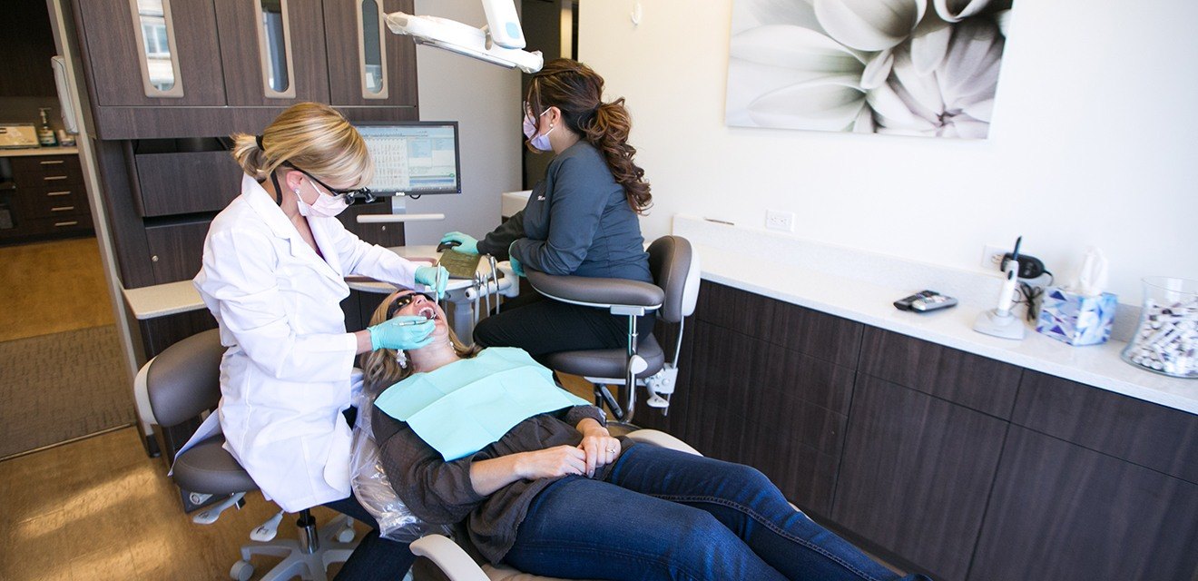 Denver dentist working on female patient
