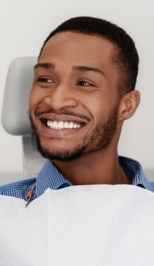 man smiling in exam chair