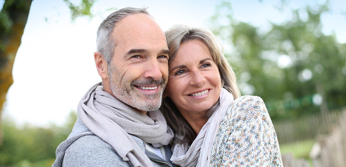 man and woman hugging and smiling