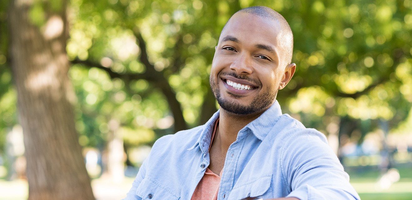 man sitting on bench smiling