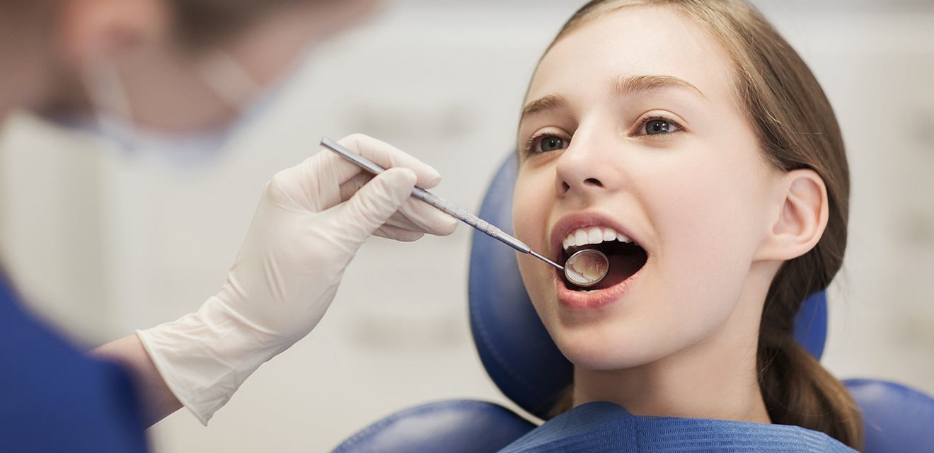 young girl having smile checked