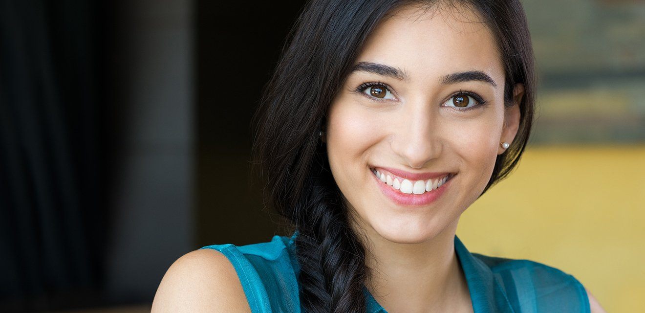 woman in blue shirt smiling