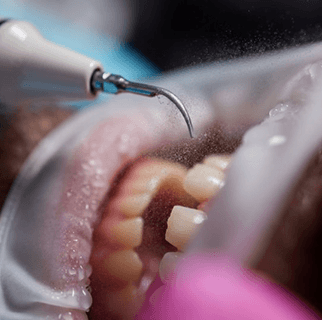 Dental receptionist smiling while helping patient with payment