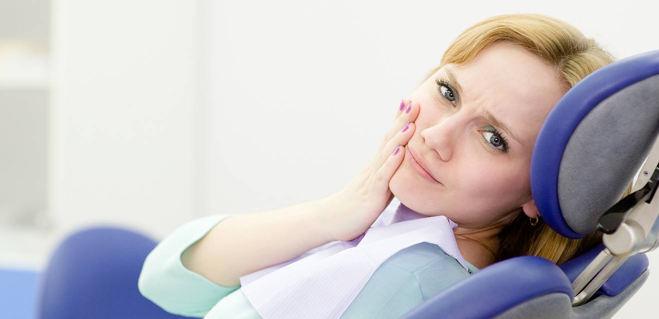 woman with hurt tooth