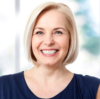 Woman smiling with dental implants in Denver