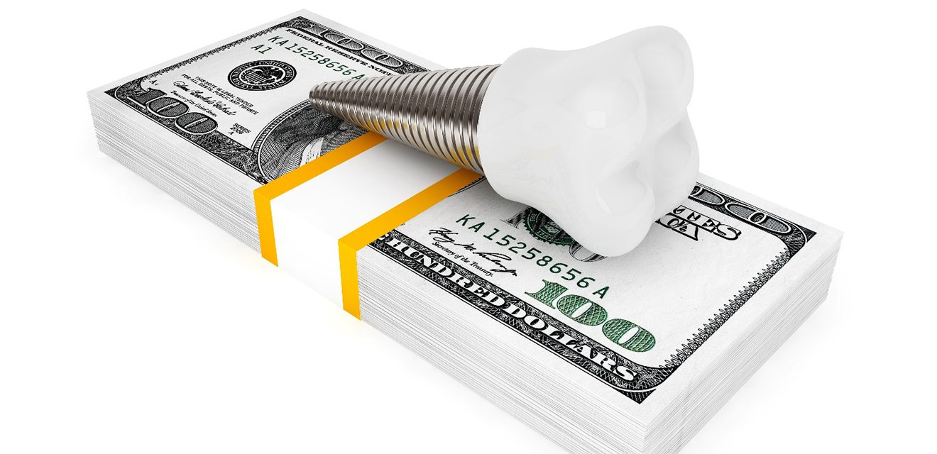 Implant on money stack representing the cost of dental implants in Devner