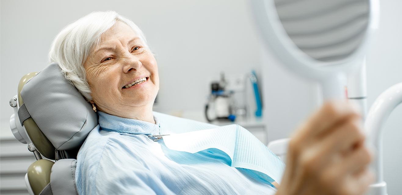 woman looking at smile in mirror