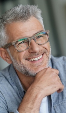 man with glasses smiling