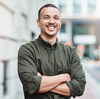 Man in green shirt smiling outside