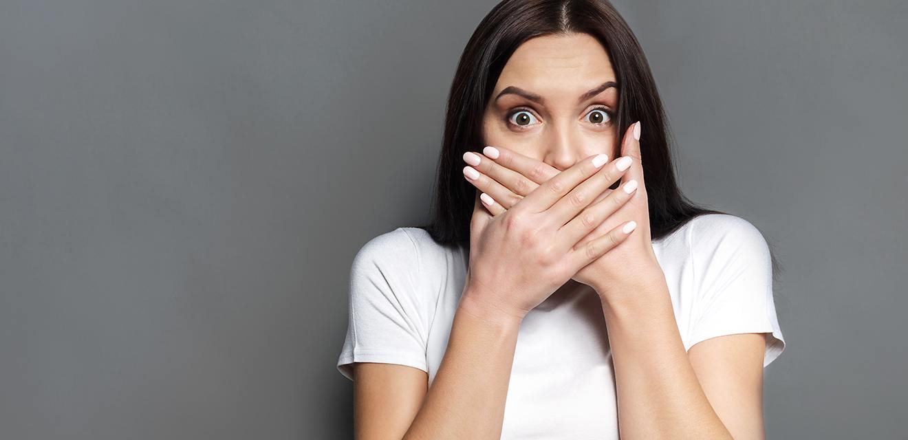 woman covering mouth