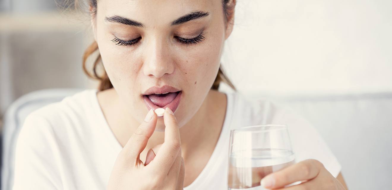 woman taking pill