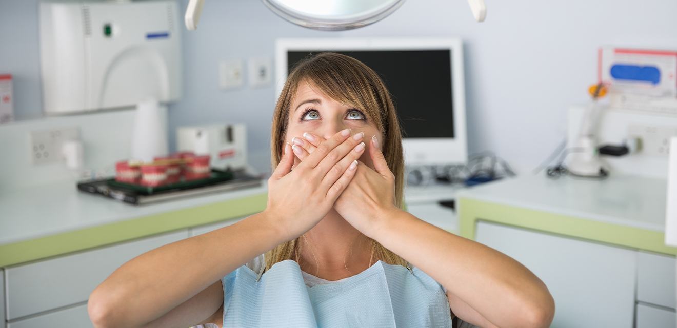 woman covering mouth with both hands