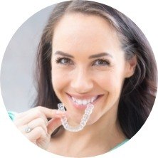 woman holding clear aligner