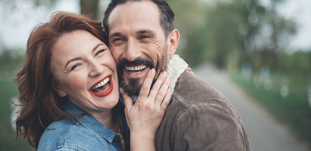 man and woman laughing together