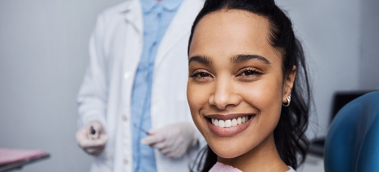 Closeup of woman with beautiful smile sitting in treatment chair 