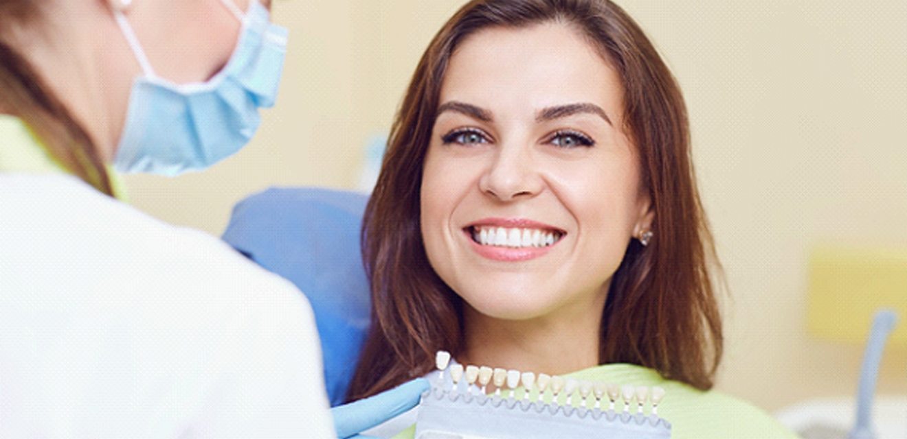 Woman smiling during consultation with cosmetic dentist in Denver
