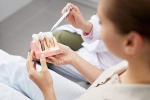 dentist showing patient a diagram of dental implants