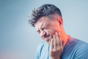 a patient suffering from dental pain