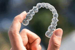 Close up of patient holding an Invisalign tray